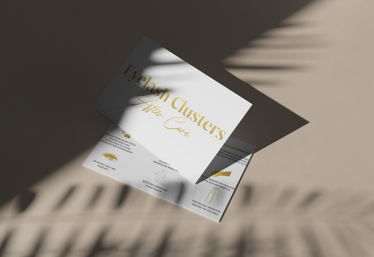 Allure Eyelash cluster aftercare cards with gold text and care instructions on a beige background