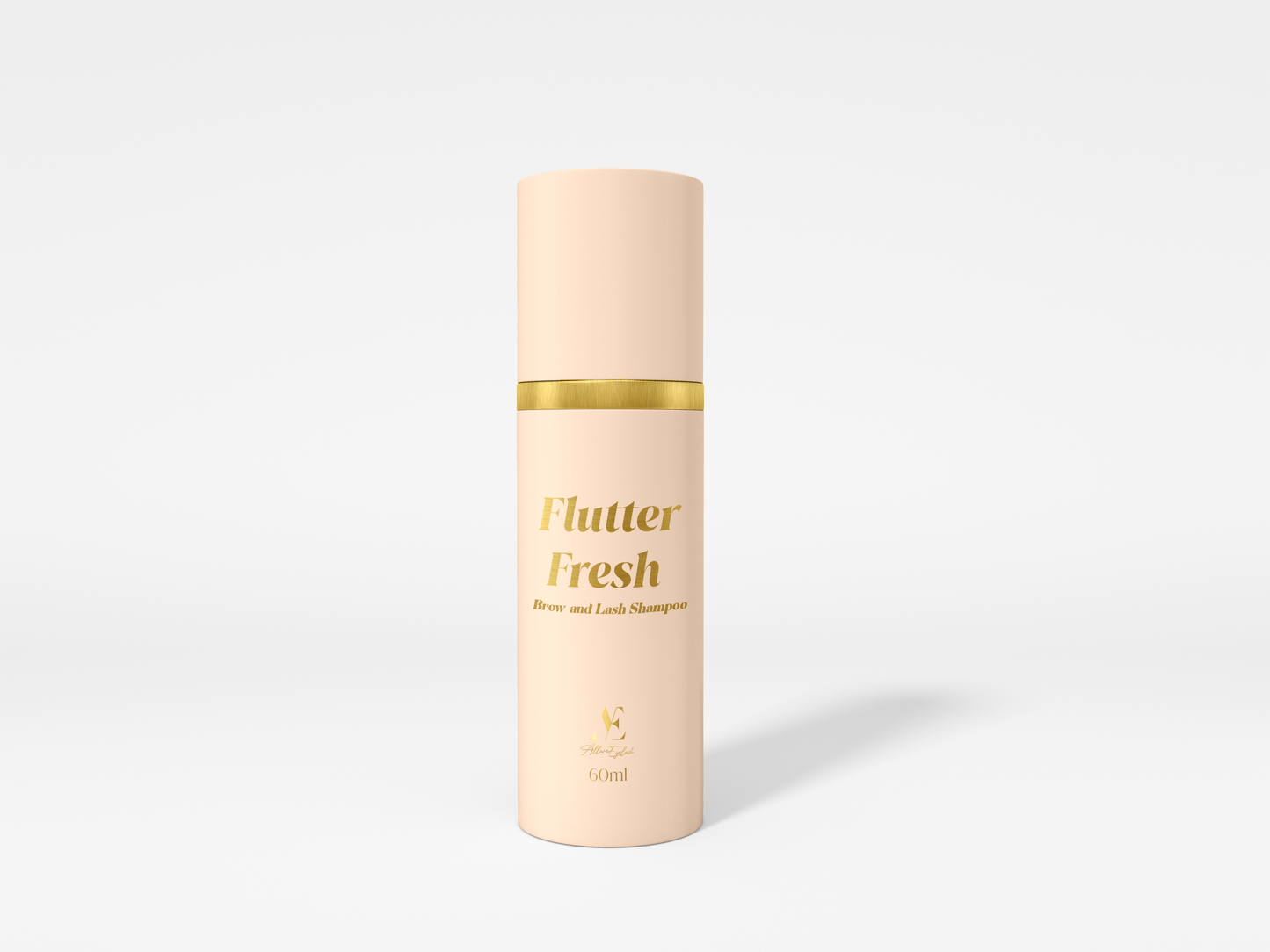 Flutter Fresh brow and lash shampoo bottle in beige with gold accents for lash tools