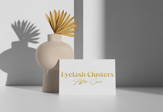 Allure Eyelash cluster aftercare cards with gold text displayed next to beige decorative vase