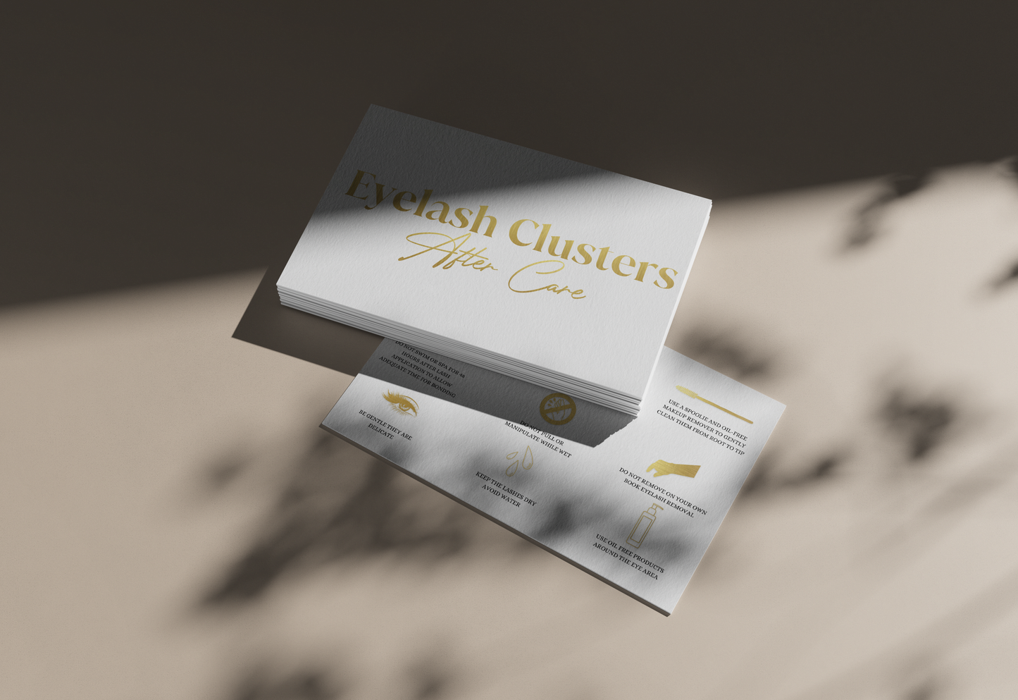 Allure Eyelash cluster aftercare cards with gold text and care instructions on a beige surface