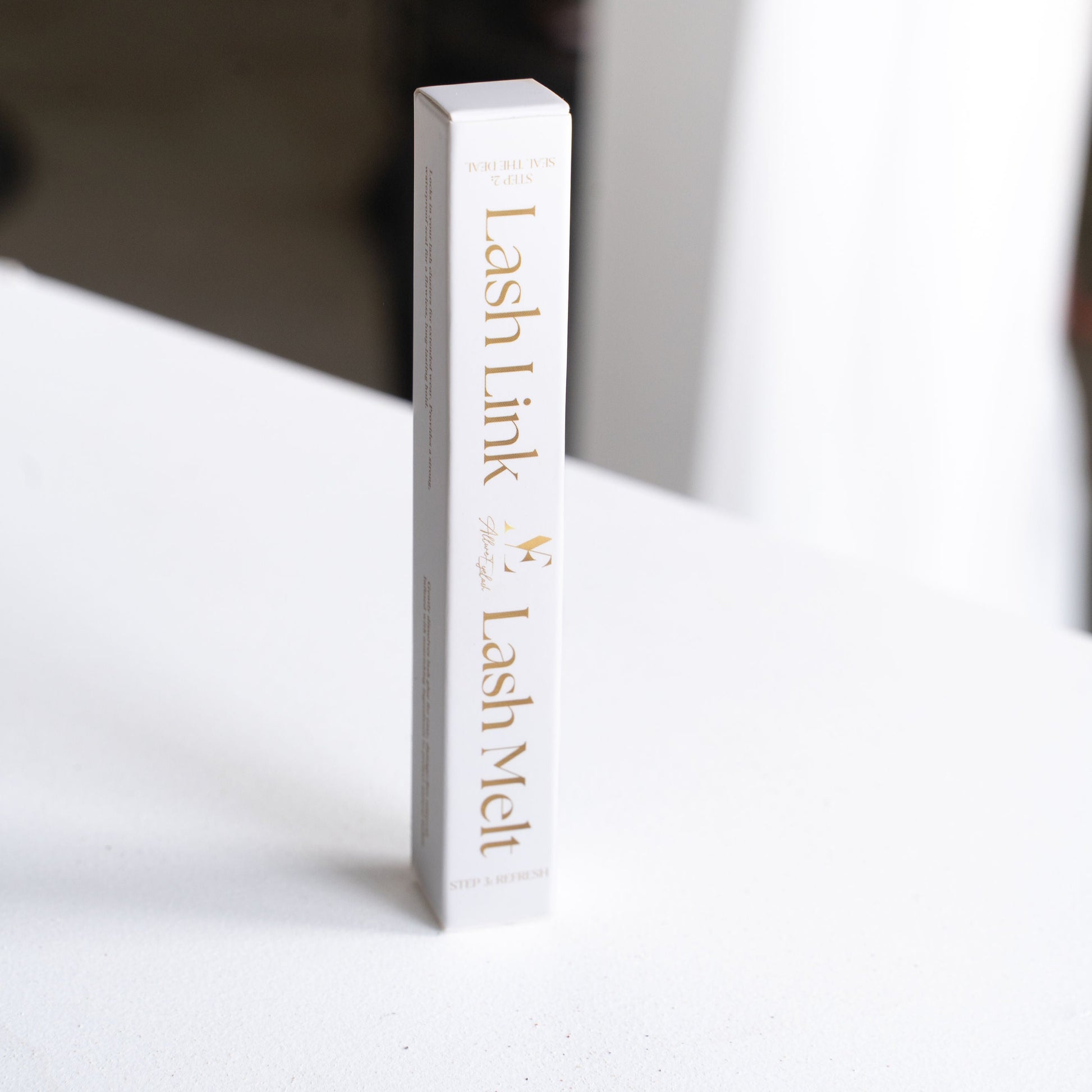 Salon quality lash sealant Lash Link and Lash Melt in white packaging on a white surface